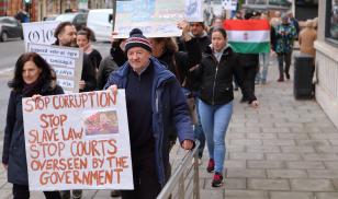 Hungarian people living in the English city marched silently through the streets in a show of solidarity with protesters in Hungary.  Bristol, England. 16 December 2018. Editorial credit: tviolet / Shutterstock.com