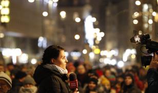 A journalist covers the scene as several hundred people rally against television propaganda in front of state outlet TVP’s headquarters in Warsaw, Poland. Photo Credit: Jaap Arriens/NurPhoto via Getty Images.