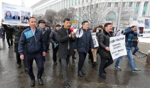 People hold a rally in memory of victims of the recent country-wide unrest triggered by fuel price increase in Almaty, Kazakhstan, February 13, 2022