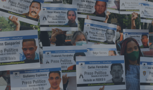 Relatives of government opponents who remain detained in different prisons hold signs with their portraits and names during a protest in Caracas in December 2020. (Image Credit: Yuri CORTEZ / AFP via Getty Images)